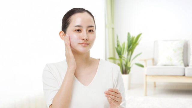 美容液をなじませた頬に触れる女性