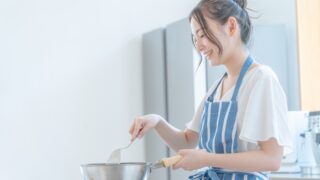 乾燥肌のケアに役立つ食べ物とレシピ。内側からの潤いを目指してキッチンで料理をする女性のイメージ
